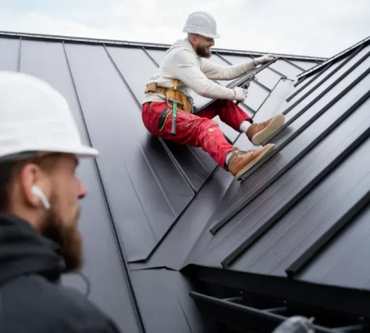 men working on a roof for roofing services